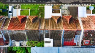 Drone shot of colorful rooftops and green spaces in Tangerang, showcasing urban residential layout.