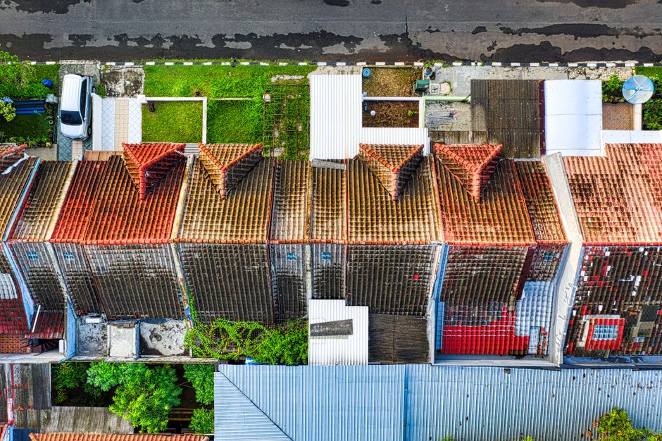 Drone shot of colorful rooftops and green spaces in Tangerang, showcasing urban residential layout.
