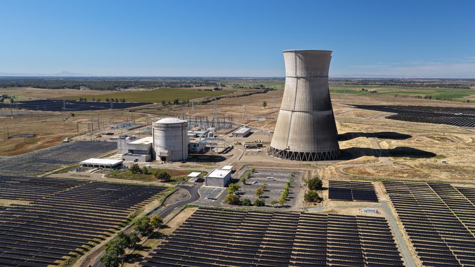 Aerial shot of Rancho Seco Solar Power Plant with large cooling tower and solar panels.