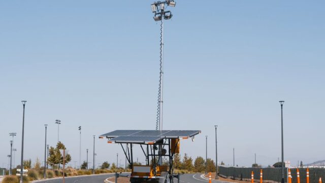 Solar powered streetlights under a clear blue sky, emphasizing renewable energy.