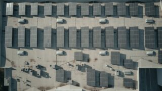 Discover the efficiency of solar energy with this aerial shot of solar panels on a rooftop.