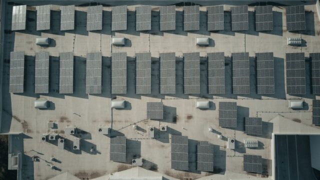 Discover the efficiency of solar energy with this aerial shot of solar panels on a rooftop.