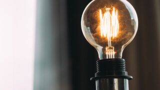 A glowing vintage light bulb adds a warm ambiance, ideal for home decor or office settings.