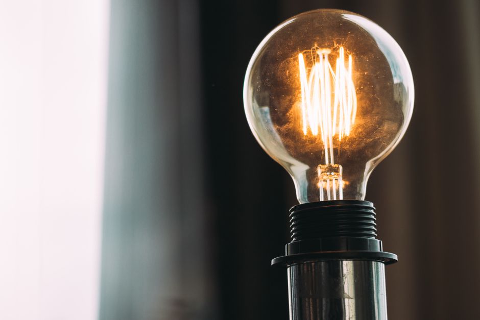 A glowing vintage light bulb adds a warm ambiance, ideal for home decor or office settings.