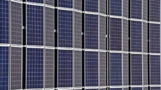 Close-up of multiple solar panels representing renewable energy and sustainability.