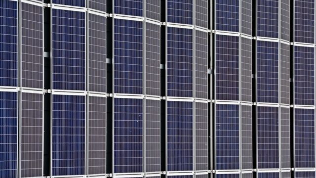 Close-up of multiple solar panels representing renewable energy and sustainability.