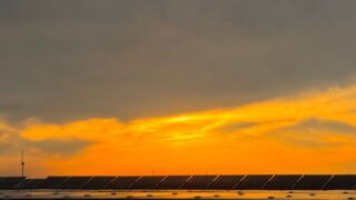 Captivating view of solar panels beneath a vibrant sunset sky in Niğde, Türkiye.