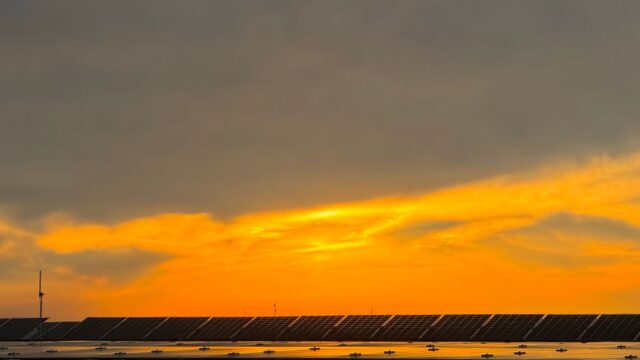 Captivating view of solar panels beneath a vibrant sunset sky in Niğde, Türkiye.