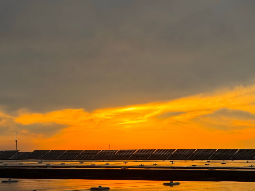 Captivating view of solar panels beneath a vibrant sunset sky in Niğde, Türkiye.