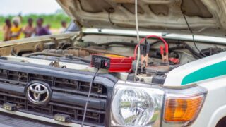 Close-up of car engine with battery charger in Blantyre, Southern Region, Malawi.