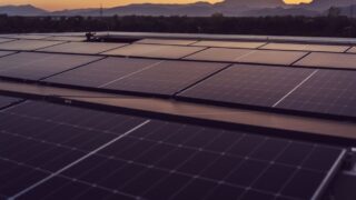 Solar panels in Styria, Austria under a serene sunset, showcasing renewable energy.