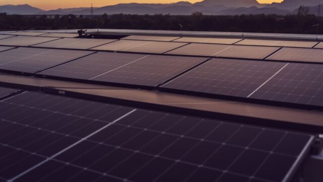 Solar panels in Styria, Austria under a serene sunset, showcasing renewable energy.