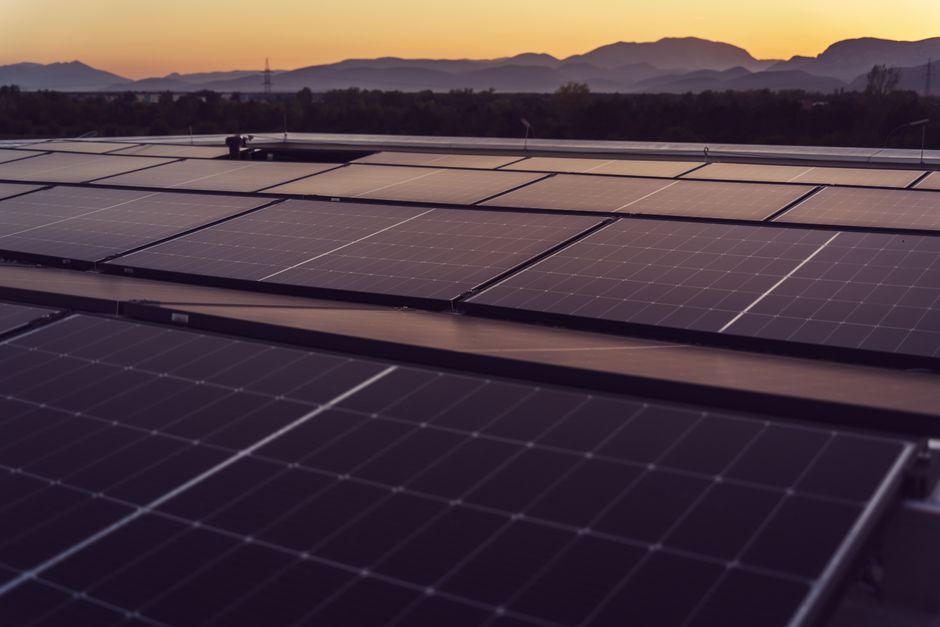 Solar panels in Styria, Austria under a serene sunset, showcasing renewable energy.