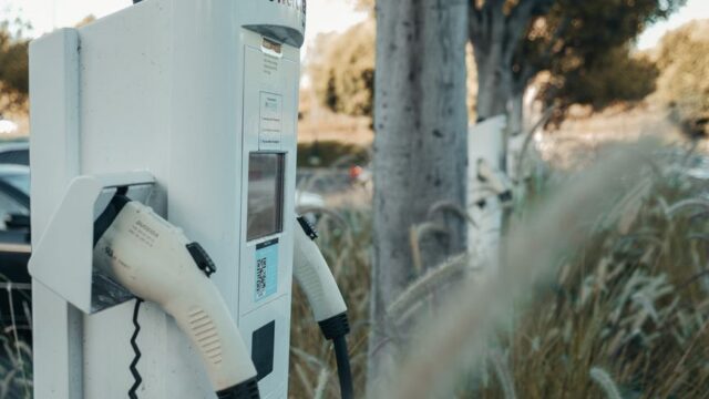 Electric vehicle charging station in an outdoor natural setting, highlighting sustainable technology.