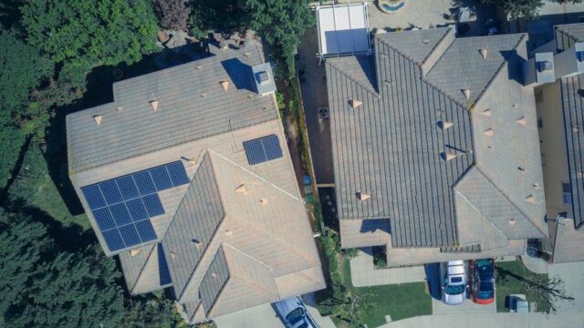 Top view of houses with solar panels, showcasing clean energy and sustainability.