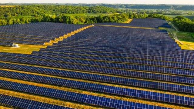Aerial view of a vast solar farm in Red Wing, MN, generating renewable energy.