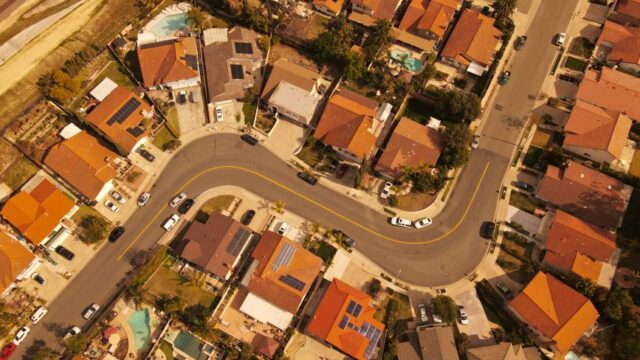 Aerial perspective of Mission Viejo residential area showcasing curved streets and solar-paneled rooftops.