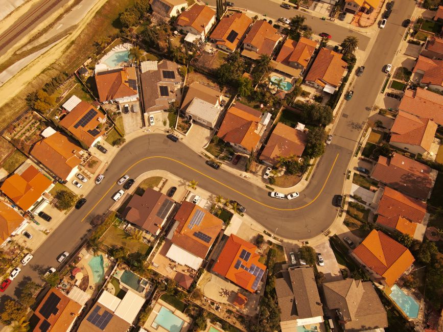 Aerial perspective of Mission Viejo residential area showcasing curved streets and solar-paneled rooftops.