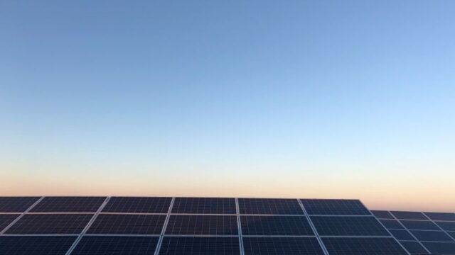 Captivating view of solar panels at sunrise highlighting renewable energy in Andria, Italy.