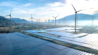 Dramatic aerial shot showcasing a wind farm and solar panels in Vietnam, illustrating the potential of renewable energy sources.