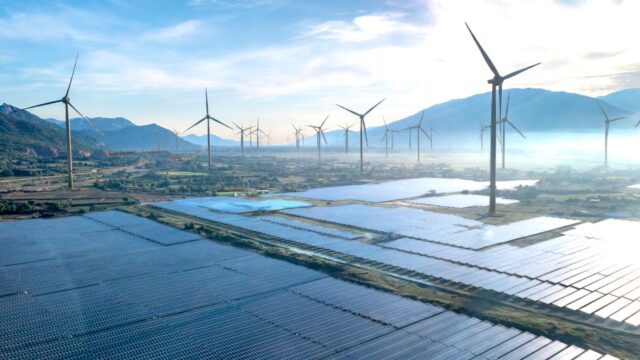 Dramatic aerial shot showcasing a wind farm and solar panels in Vietnam, illustrating the potential of renewable energy sources.