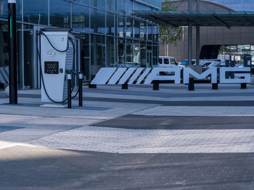 Electric vehicle charging station at a modern business complex featuring sleek architectural design.