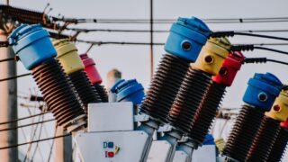Colorful high voltage insulators in an electric substation highlighting power infrastructure.
