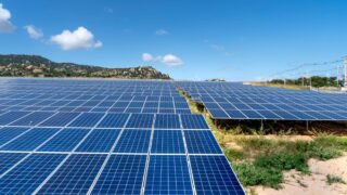 A vast field of solar panels harnessing solar energy on a sunny day.