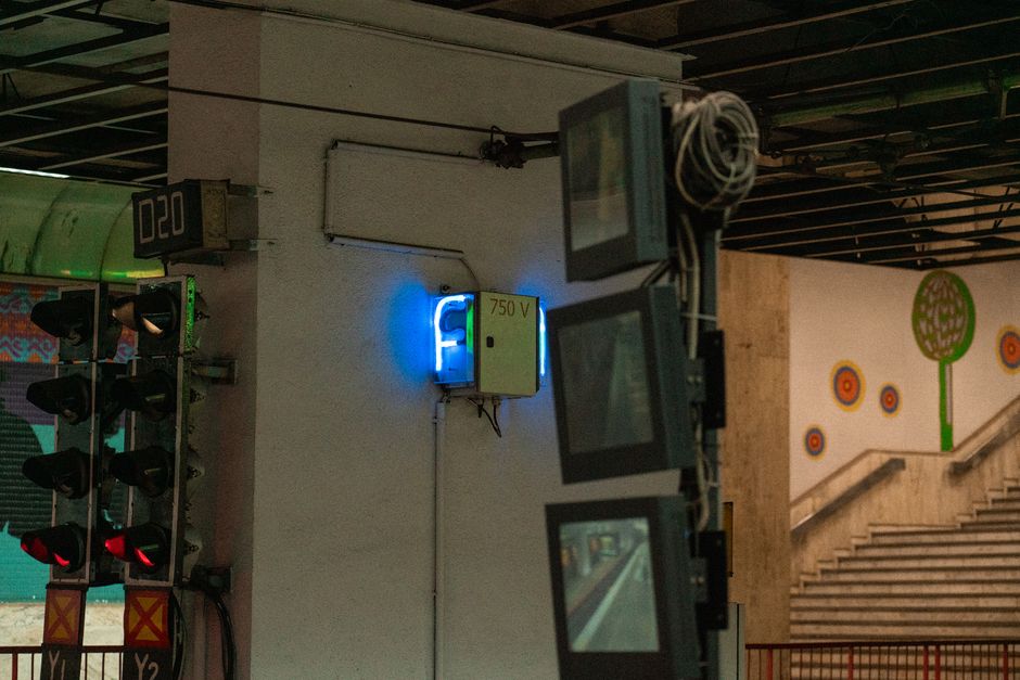 Urban subway station in Bucharest showcasing an electrical panel and vibrant wall art.