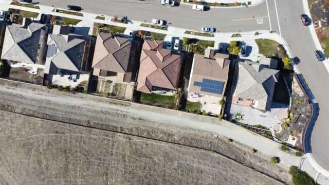 Overhead view of suburban houses with solar panels in Dublin, CA neighborhood.