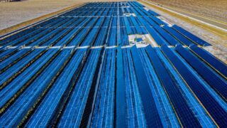 Expansive aerial view of solar panels in Claremont, MN, highlighting renewable energy.