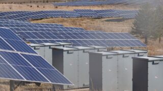 Expansive solar panel field in a rural area harnessing solar energy. Sustainable and renewable energy source.