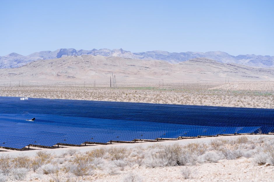 Stunning view of a large solar farm harnessing energy in a vast desert landscape.