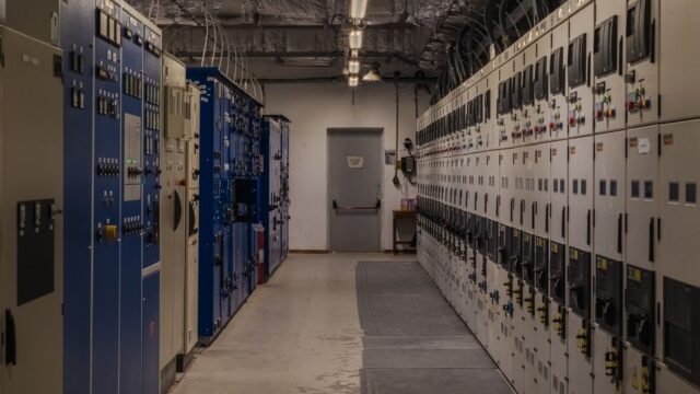 A sophisticated control room filled with electrical panels and equipment for industrial purposes.