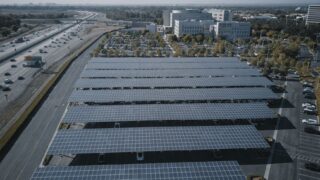 Aerial view of extensive solar panels in an urban setting, showcasing renewable energy.