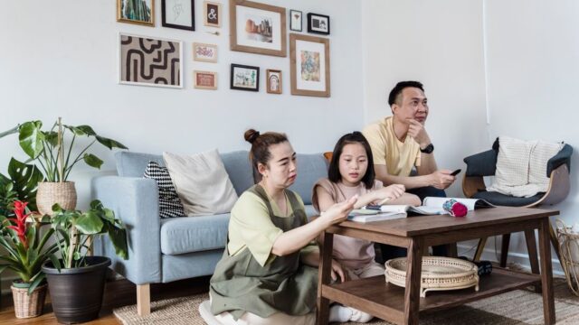 A family enjoying quality time at home in a cozy and stylish living room setting.