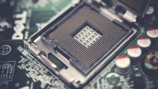 Detailed view of a CPU socket on a circuit board, highlighting electronic components.