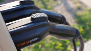 Detailed view of ChargePoint electric vehicle charging plugs at a station outdoors.