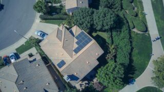 An aerial view showcasing modern suburban houses equipped with solar panels for renewable energy.
