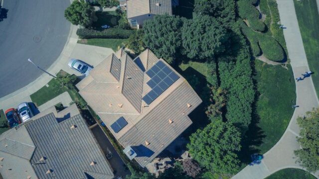 An aerial view showcasing modern suburban houses equipped with solar panels for renewable energy.