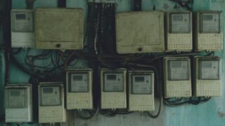 Aged and rusty electrical panels on an outdoor wall in Ho Chi Minh City, Vietnam.