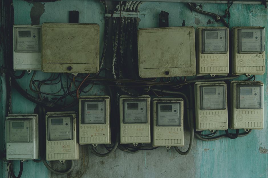 Aged and rusty electrical panels on an outdoor wall in Ho Chi Minh City, Vietnam.
