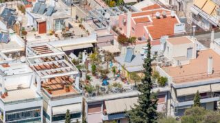 Vibrant urban rooftop gardens with solar panels in a residential district.