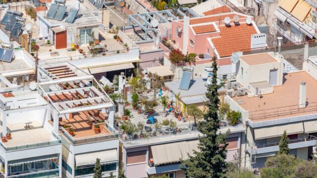 Vibrant urban rooftop gardens with solar panels in a residential district.