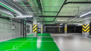 Modern green electric car charging station in an underground parking lot, eco-friendly urban solution.