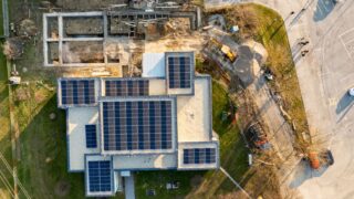 Top-down view of a building with solar panels and construction work in progress.