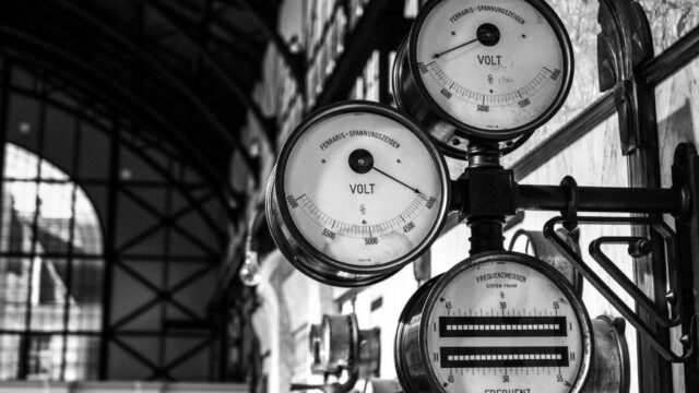 Black and white image of antique voltage gauges in a historic Dortmund building.