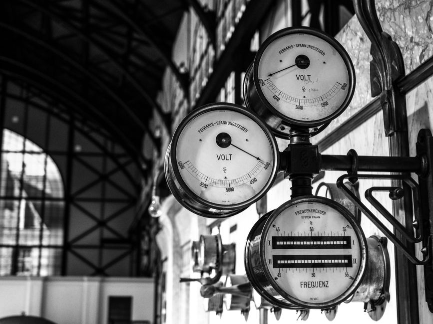 Black and white image of antique voltage gauges in a historic Dortmund building.