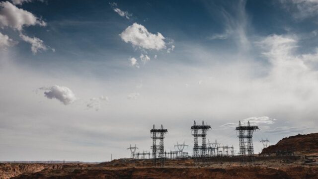 High-voltage power lines stretch across the desert landscape at North Rim, Arizona