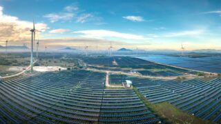 Panoramic aerial shot of a solar and wind farm in Vietnam showcasing renewable energy technologies.